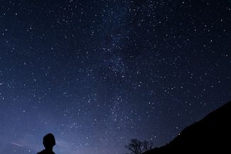 silhouette of person walking at night