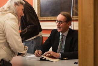 Man signing book at festival