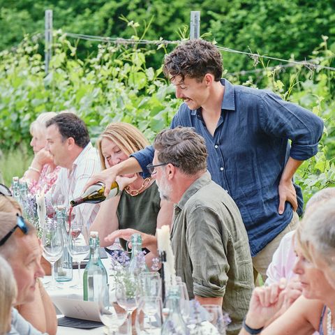 People drinking and dining in the vineyard at Wythall Estate