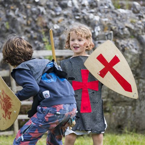 Children dressed as knights sparring 