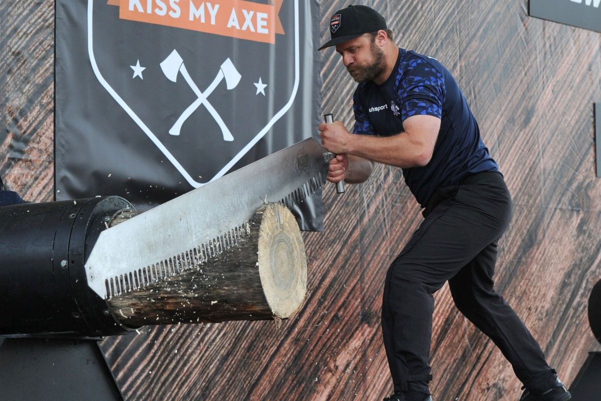 man sawing giant log