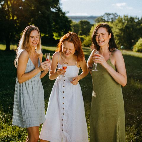 girls outdoors in garden drinking and smiling