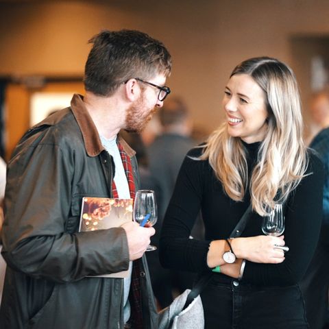 Couple chatting at wine tasting event