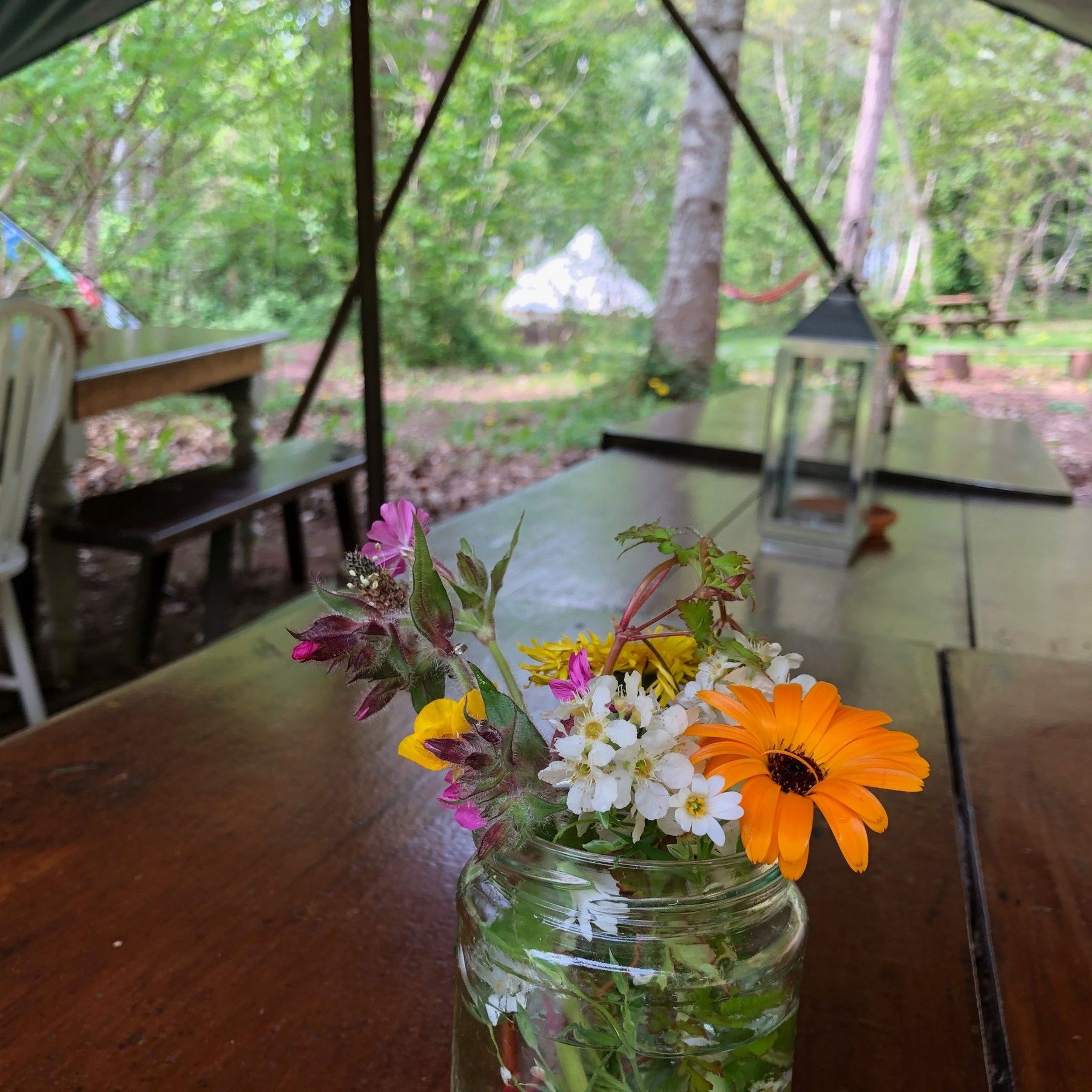 Hand picked flowers on the tables under the awning