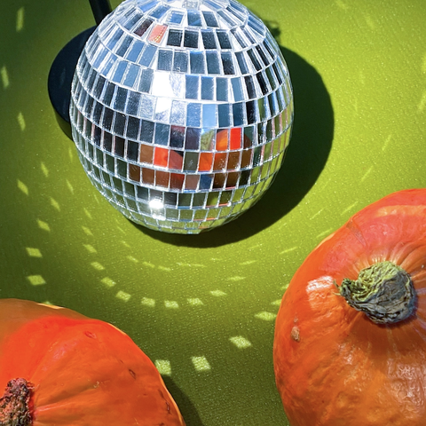 pumpkins next to disco ball 