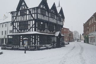 Tudor timber framed building in the snow