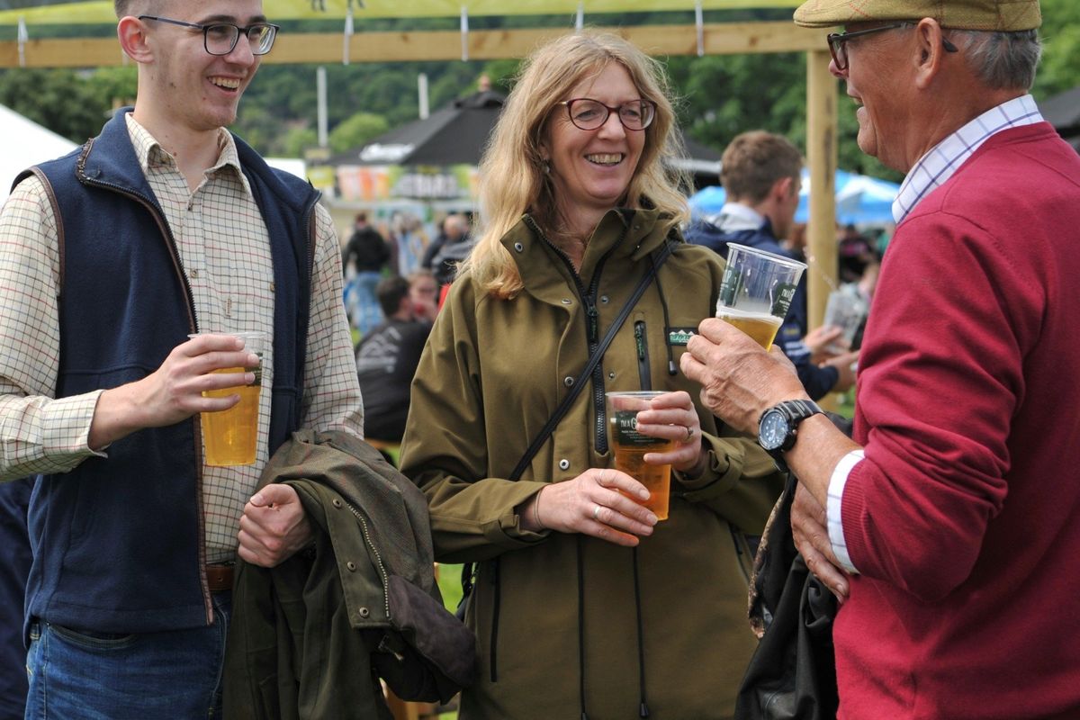people chatting and drinking cider