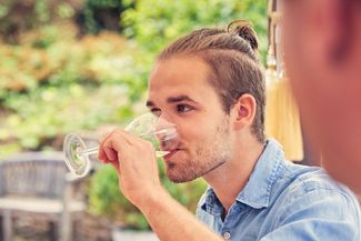 Young man tasting wine at Frome valley