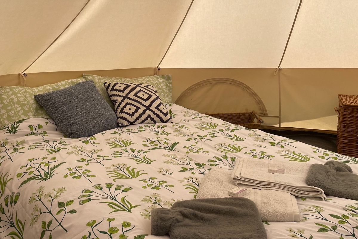 Double bed inside canvas bell tent